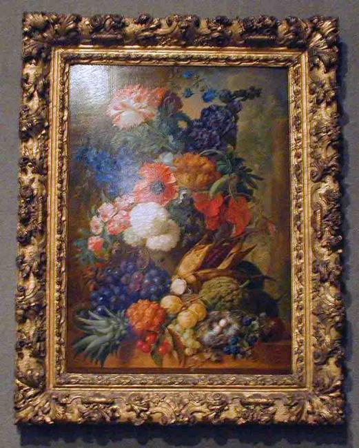 Still life of fruit and flowers with bird's nest on a marble ledge