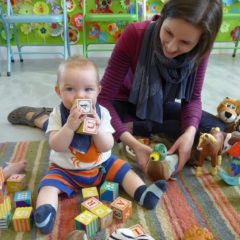 Mother and young child in play area