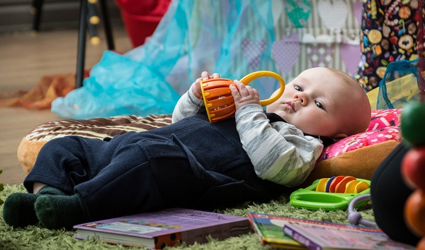 Baby playing with rattle