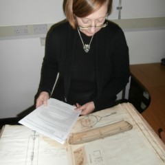 Mary Brooks examining one of the huge volumes