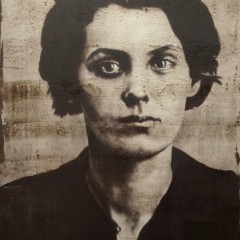 An oil painting in black and white taken using a passport photo of a woman staring at the viewer