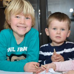 Four young children smiling at a camera.