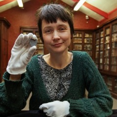 Dr Chantal Conneller (The University of Manchester) with the 11,000 year old engraved shale pendant discovered by archaeologists during excavations at the Early Mesolithic site at Star Carr in North Yorkshire. Image taken at the Yorkshire Museum, York. Credit: Suzy Harrison