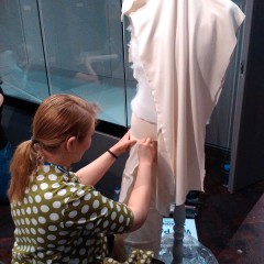 Volunteer Anni working on one of the garments in the new exhibition.