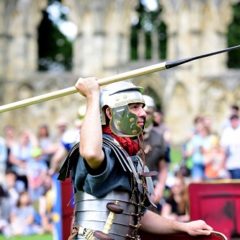 Roman re-enactor holds up a javelin