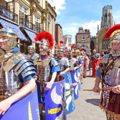 Group of re-enactors dressed as Roman soldiers marching through York