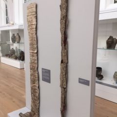 Two large vertical pieces of ceramic on display in an art gallery