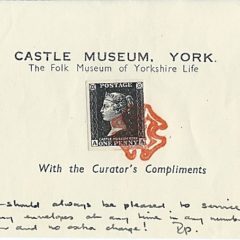 Compliments slip with postage stamp and red ink symbol