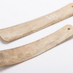 Two long pieces of bone carved flat