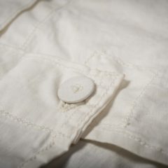 Close up of white fabric with button