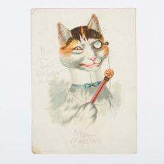 An illustration of a cat wearing a monocle and a bow tie, and holding a staff. The illustration has 'Boys! I'm a Dudelet, quite English you know. A happy Christmas!' written on it.