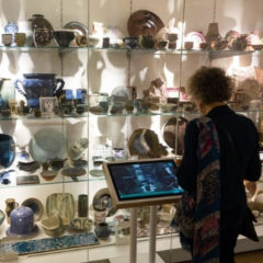 A visitor stood in front of a ceramic art display.