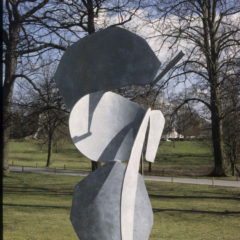 A grey sculpture in an outdoor space.