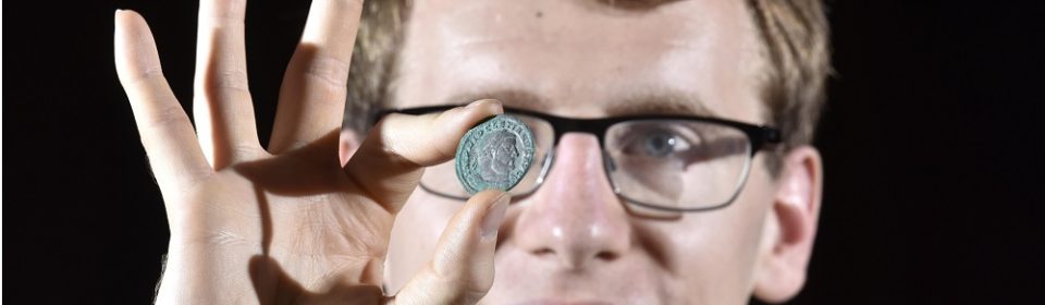 York Museums Trust's curator of numismatics Dr Andrew Woods with one of the coins from the Wold Newton Hoard (image © Anthony Chappel-Ross)