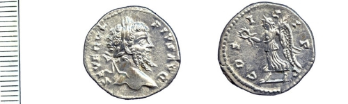 The front and back of a silver Roman coin.