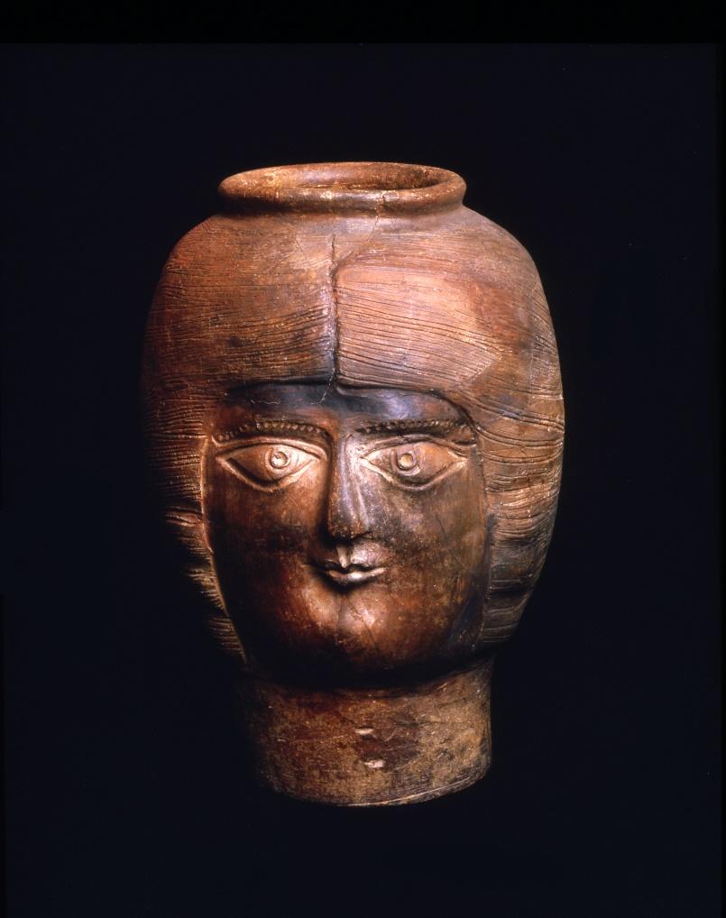 A brown pot resembling a person's head.