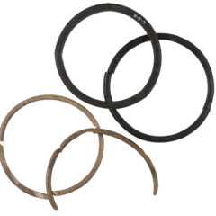 Two bangles of black jet and two bangles of white ivory are shown on a white background.